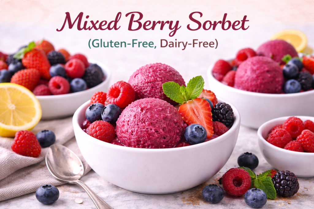 A close-up of gluten-free, dairy-free mixed berry sorbet served in bowls, garnished with fresh raspberries, blueberries, strawberries, and mint leaves, with a soft pastel background.